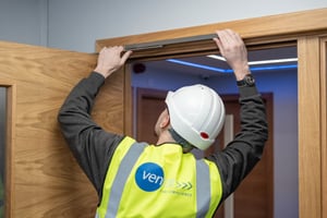 High vis Man checking fire door 