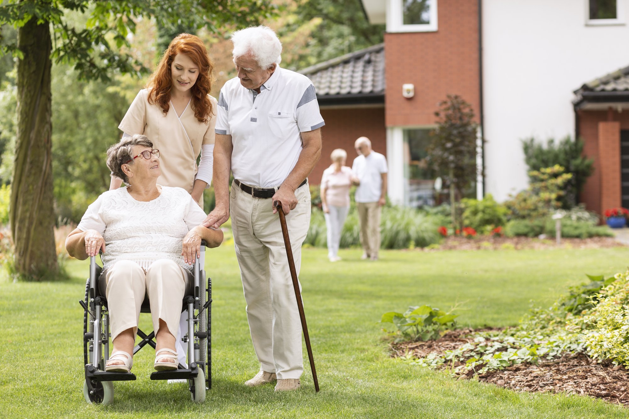 an-elderly-disabled-couple-with-their-caretaker-in-2021-04-02-19-13-18-utc